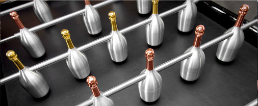 Table football with Ruinart champagne bottles as players